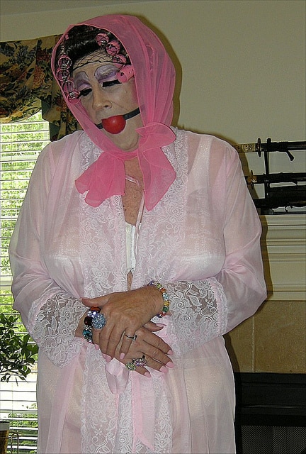 A Day In The Life Of A Sissy is depicted in this photograph, and the aunty appears to be depressed, wearing a pink outfit and a white bra. This is what happens if you remain with Auntie Gina.